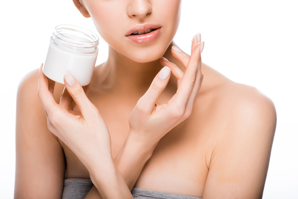 stock-photo-cropped-view-woman-holding-container-while-applying-cosmetic-cream-isolated